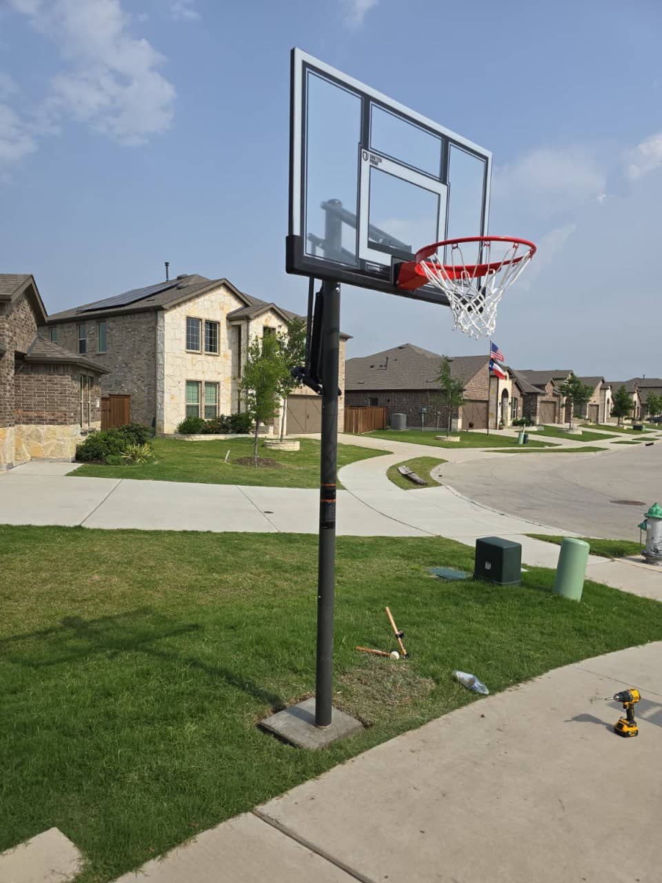 In-ground basketball hoop system installed on a residential driveway